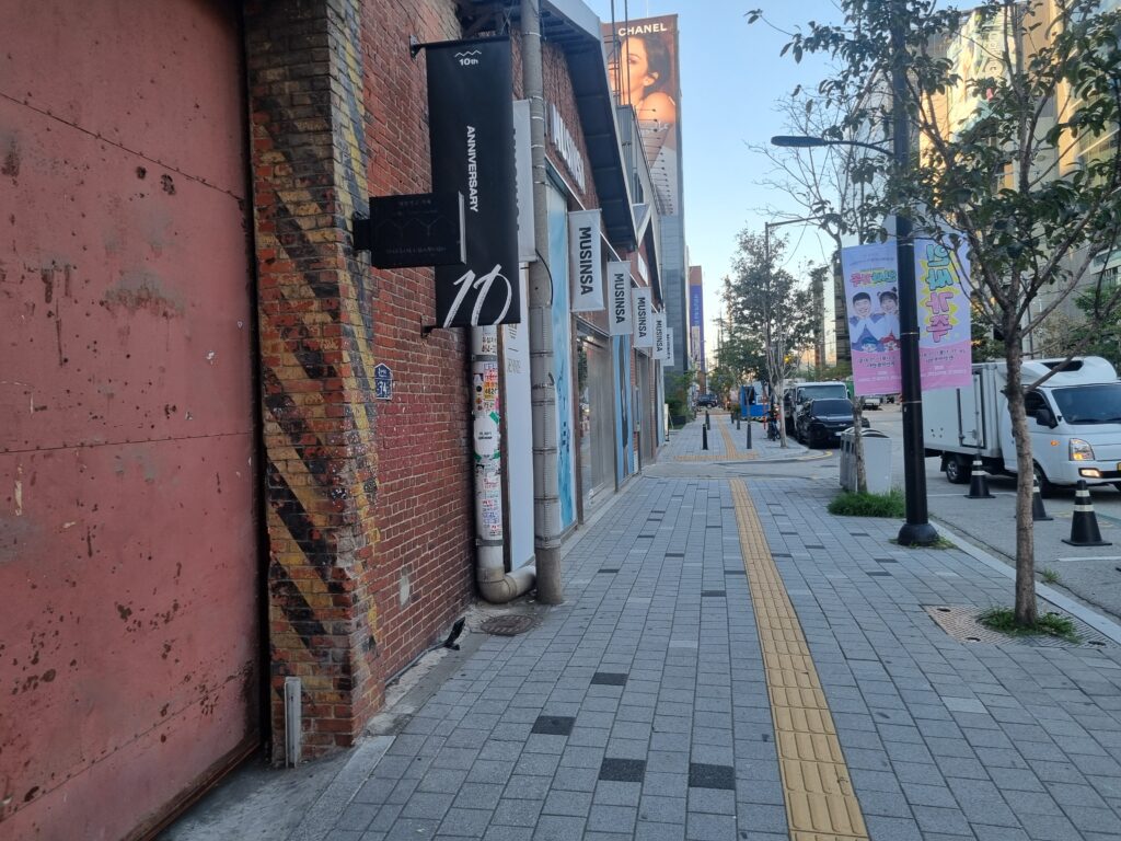 Seongsu-dong sidewalk with converted industrial buildings and urban shops in Seoul