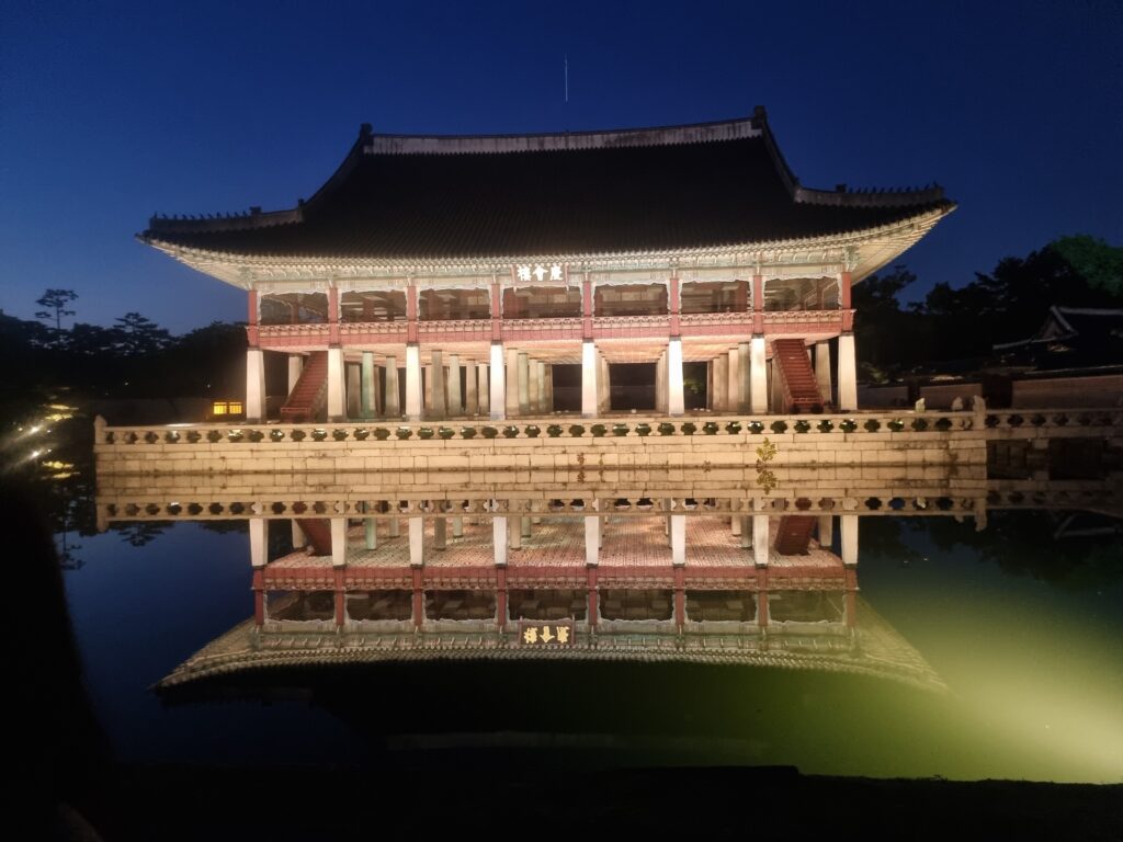 Gyeongbokgung Palace at night reflected in a pond in Seoul