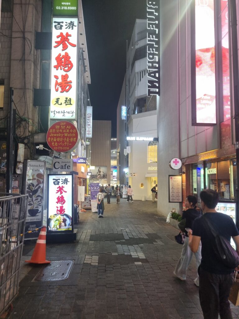 Myeongdong alley at night with restaurants, shops, and illuminated signs in Seoul