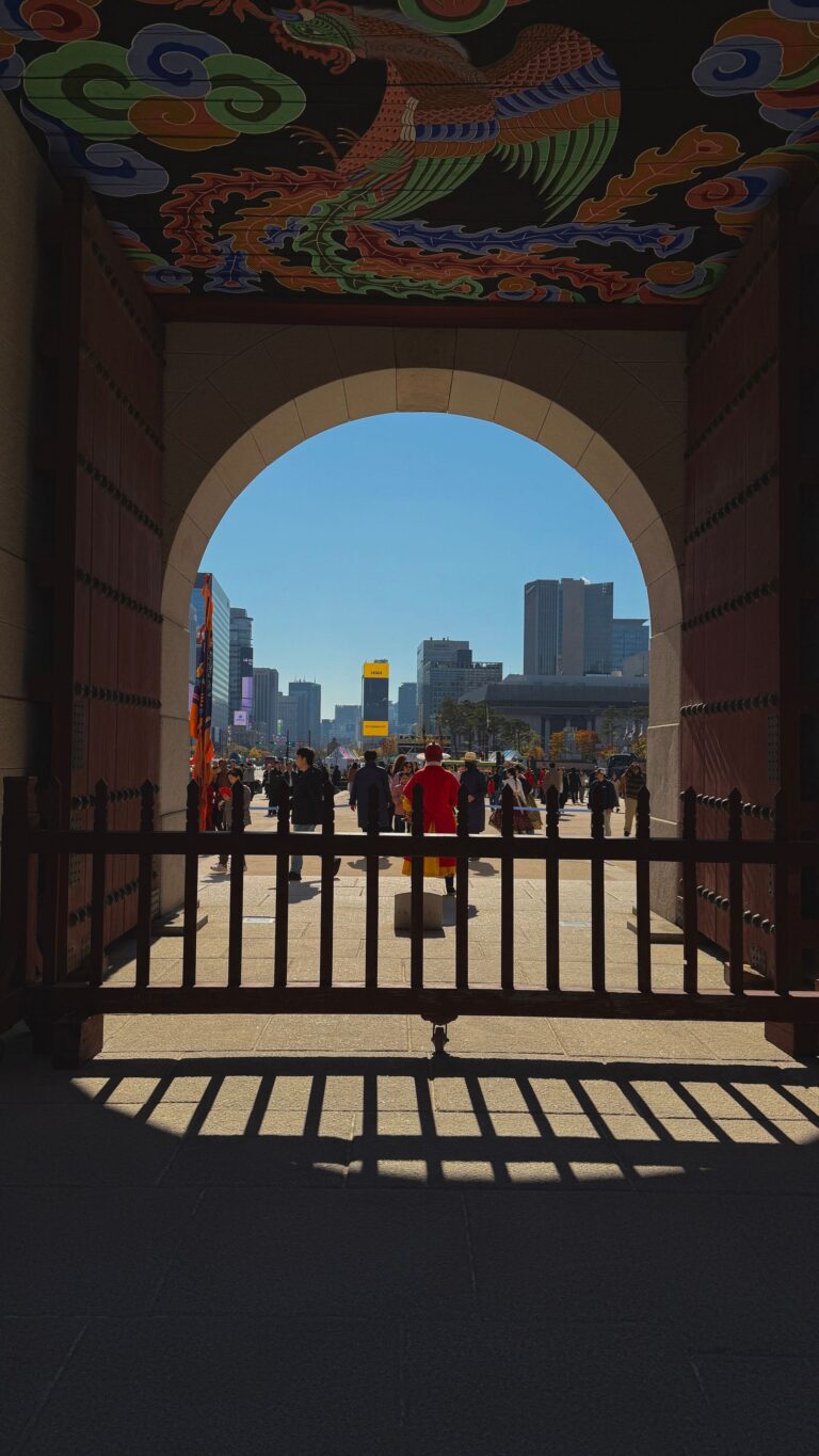 View of Gwanghwamun Square and Seoul city skyline through the gate of Gwanghwamun Gate